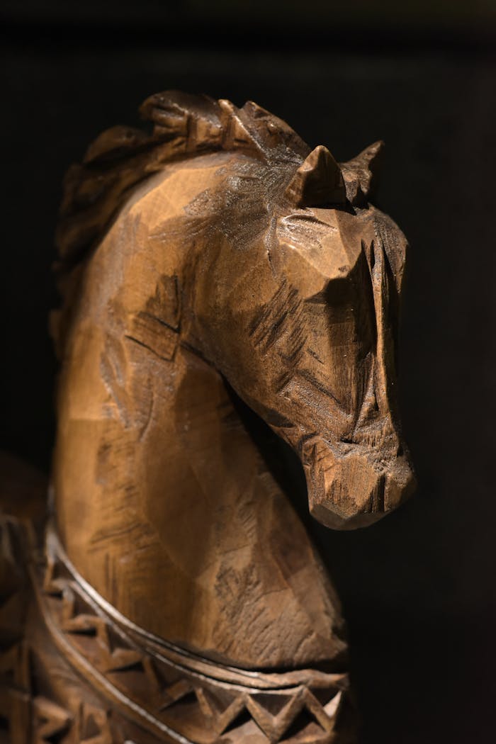 Detailed wooden horse carving with intricate patterns and textures.